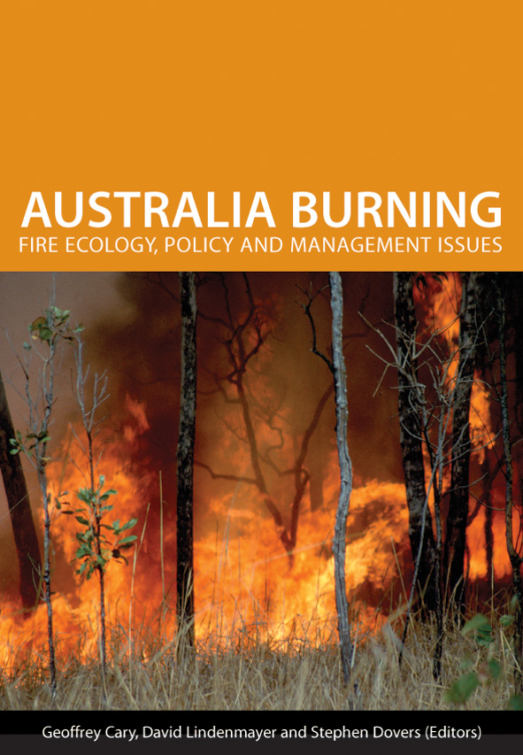The cover image of Australia Burning, featuring a raging fire, with trees on fire and long dry grass in the foreground.