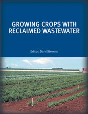 The cover image of Growing Crops with Reclaimed Wastewater, featuring a view of small green lines of growing produce with red dirt and blue skies.
