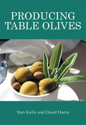 The cover image of Producing Table Olives, featuring a small white bowl of green olives with leaves sticking out the side sitting on a table.