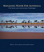 The cover image of Managing Water for Australia, featuring a panoramic view of sparse trees in red land reflected in flat water.