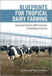 Cover featuring several dairy cows standing in front of a milking shed.