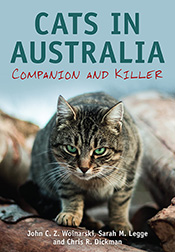 Cover of Cats in Australia featuring a crouching green-eyed cat glaring di
