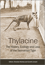 Cover of 'Thylacine' featuring a historical photo of a Tasmanian tiger within an enclosure.