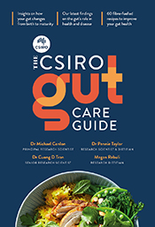 Cover of The CSIRO Gut Care Guide, showing the title in white and orange font on a dark blue background, above a bowl of chicken and spiced rice with