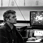 A black-and-white photograph of Dr Angus McEwan and his ‘rotating table’ at the CSIRO Aspendale laboratory.