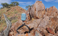 Photograph of a camera trap deployed on a typical rocky landform in the Mount Isa Inlier.